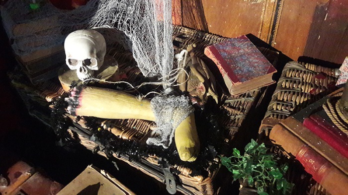 Display including fake bloodied leg, skull, dusty old books and lace netting