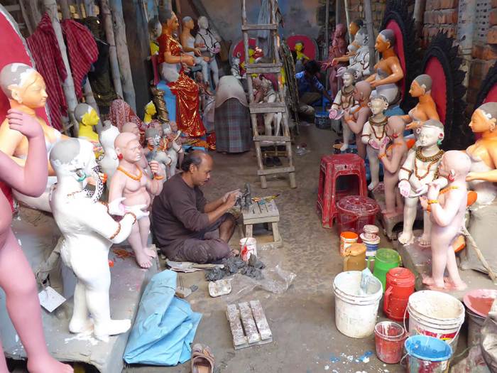 Artist painting and working on statues of gods and godesses